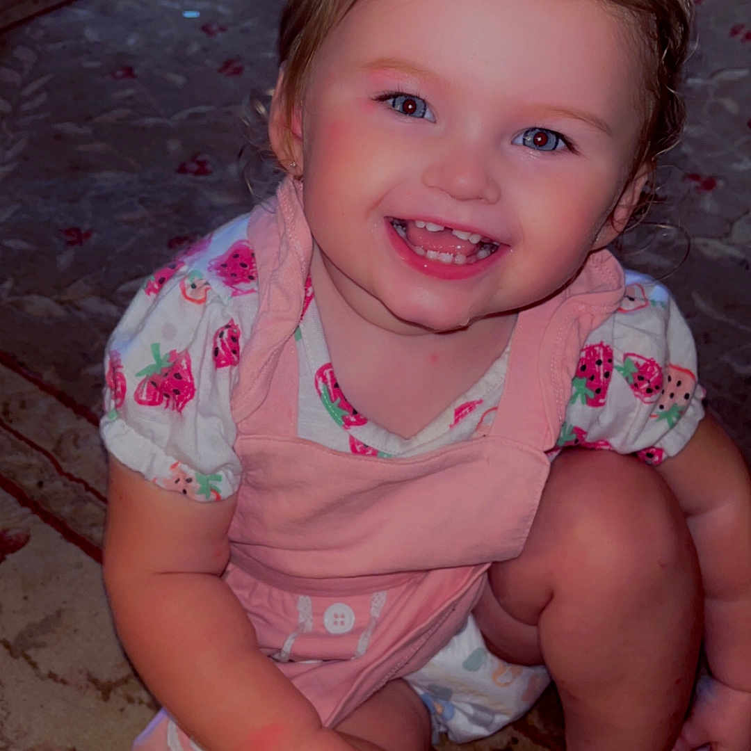 Makayla joined the competition — help win amazing prizes! candid, carpet, child, cute, dress, face, fashion, happy, home, indoor, infant, pink_bow, playful, portrait, shoes, sitting, smiling, strawberry_print, toddler, young_child