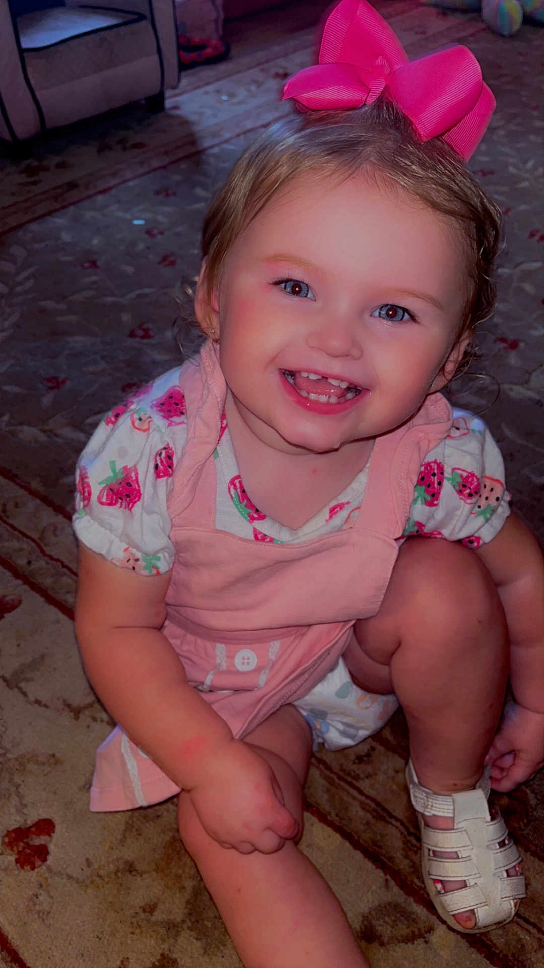 Makayla joined the competition — help win amazing prizes! toddler, child, smiling, pink_bow, strawberry_print, dress, sitting, carpet, indoor, happy, cute, shoes, face, portrait, young_child, playful, candid, infant, fashion, home