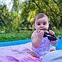 baby, child, sunglasses, blanket, outdoor, nature, grass, summer, cute, curious, sitting, greenery, infant, clothing, portrait, daylight, playful, pink, young, sunlight
