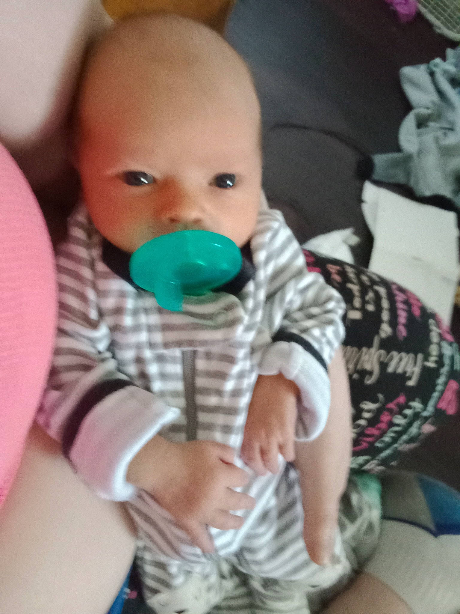 Cole is registered to the contest to win money with this photo: arm, baby, baby_playing_with_toys, baby_products, baby_toddler_clothing, cheek, child, comfort, face, finger, happy, head, iris, linens, mouth, nose, person, sitting, skin, sleeve