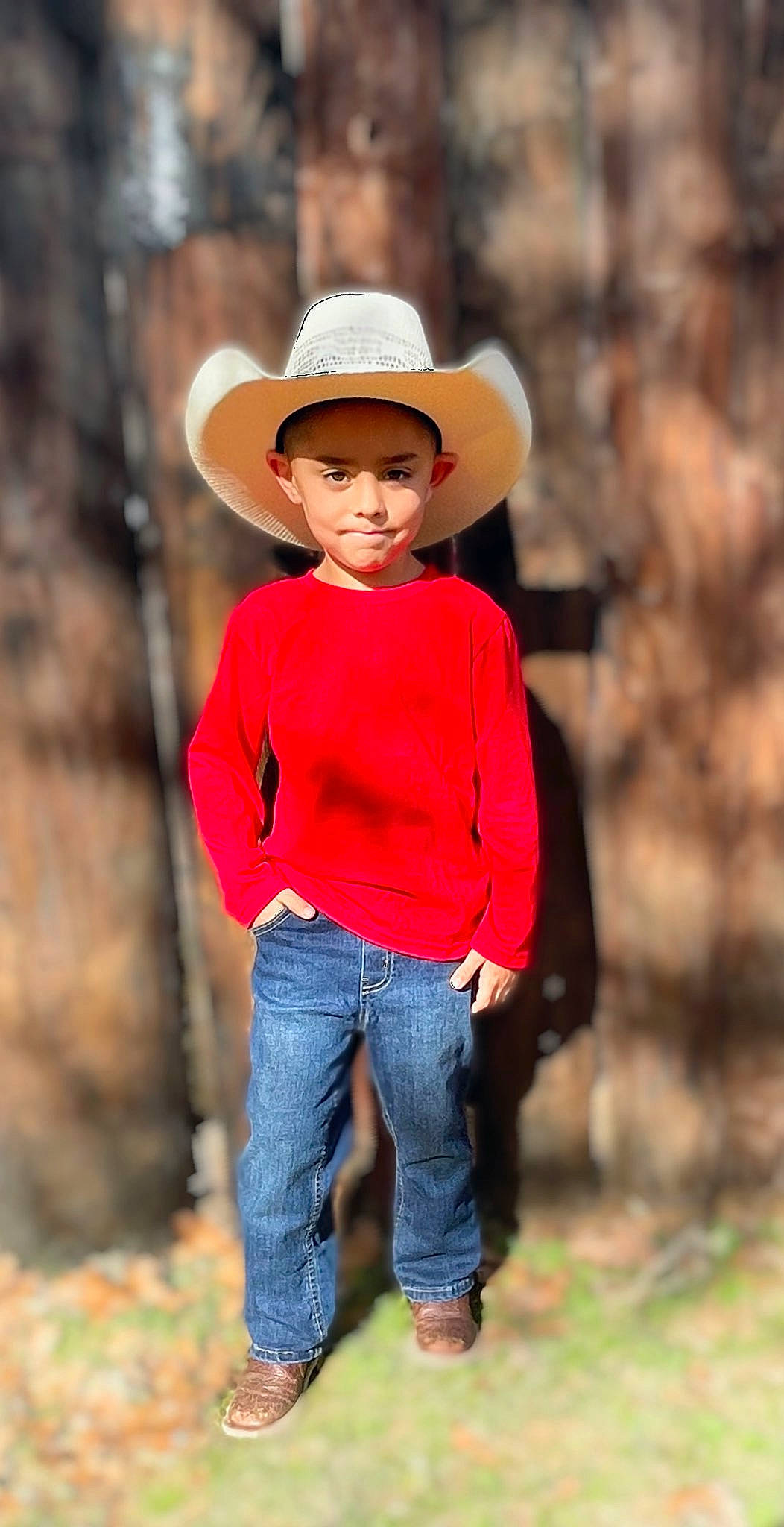 Leland is registered to the contest to win money with this photo: clothing, dress, eye, face, fawn, hair, happy, hat, headwear, jeans, people_in_nature, person, plant, sleeve, smile, street_fashion, sun_hat, toddler, tree, waist