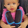 baby, child, car_seat, harness, pink_shirt, blue_eyes, hands, infant, cute, sitting, safety, colorful_pants, young_child, portrait, seat_belt, close_up, indoor, person, kid, strapped_in