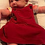 baby, infant, red_dress, cushion, baby_seat, foot, arm, face, clothing, cute, newborn, indoors, soft_toy, child, relaxing, sleepwear, skin, head, person, young