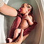 arm, baby, bath, bathtub, care, closeup, cloth, foot, hands, human, infant, newborn, nurturing, pacifier, peaceful, relaxation, skin, supporting_hands, tenderness, water