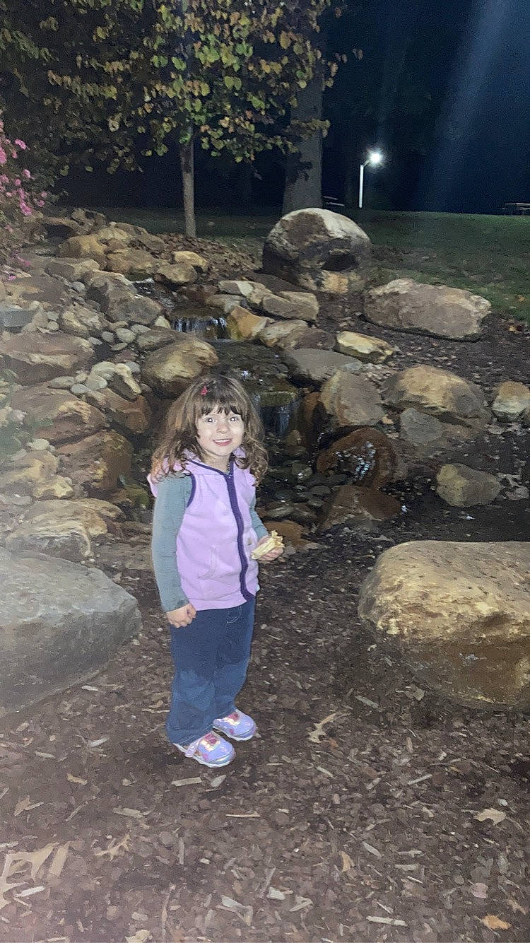 Amelia is registered to the contest to win money with this photo: bedrock, boot, child, fun, garden, grass, joy, landscape, leisure, night, person, plant, rock, soil, stream, toddler, tourism, tree, vacation, water_feature