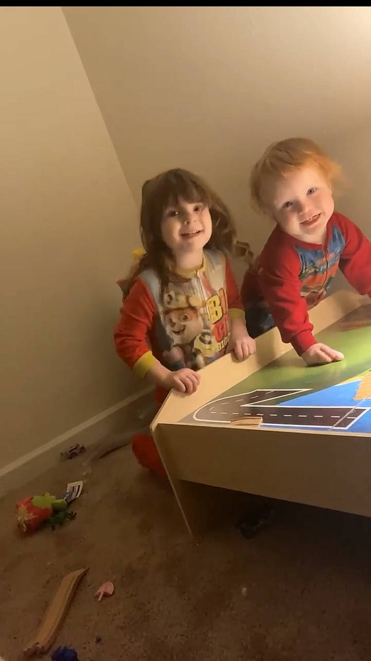 Ashtyn is registered to the contest to win money with this photo: arm, artist, child, dress, flooring, fun, hand, happy, joy, leisure, person, play, reading, room, sitting, smile, t_shirt, table, tablet_computer, toddler