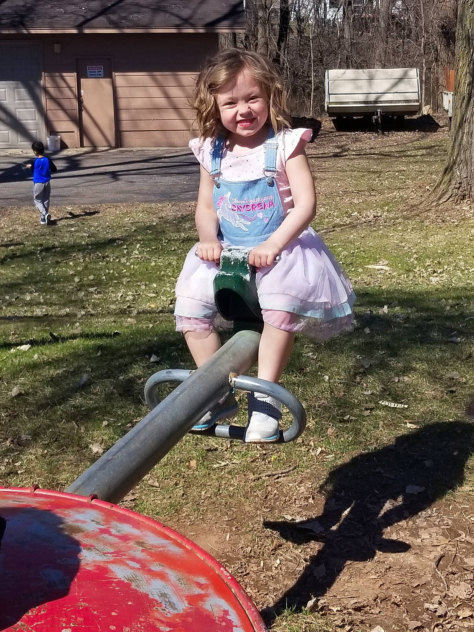 Nataliya is registered to the contest to win money with this photo: child, city, fun, grass, human_settlement, joy, leg, outdoor_play_equipment, person, play, playground, public_space, recreation, soil, toddler