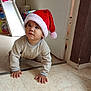 baby, child, clothing, crawling, curious, cute, expression, festive, floor, headwear, holiday, home, indoor, infant, person, playroom, santa_hat, slide, toy, young_child
