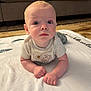 Levi is registered to the contest to win money with this photo: baby, blanket, blue_eyes, carpet, child, couch, curious, cute, floor, hands, home, indoor, infant, light_skin, looking, portrait, resting, soft, tshirt, young