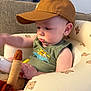 Levi joined the competition — help win amazing prizes! baby, cap, child, curious, cushioned_seat, cute, focused, furniture, green_shirt, hat, indoor, infant, light, person, plush_toy, seated, sleeveless, soft_toy, teddy_bear_prints, young_child