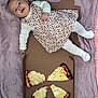 baby, blanket, cardboard_box, casual, cheese_pizza, child, cute, dress, food, happy, indoor, infant, lying_down, person, pizza, pizza_box, smiling, snack, tights, white_clothing