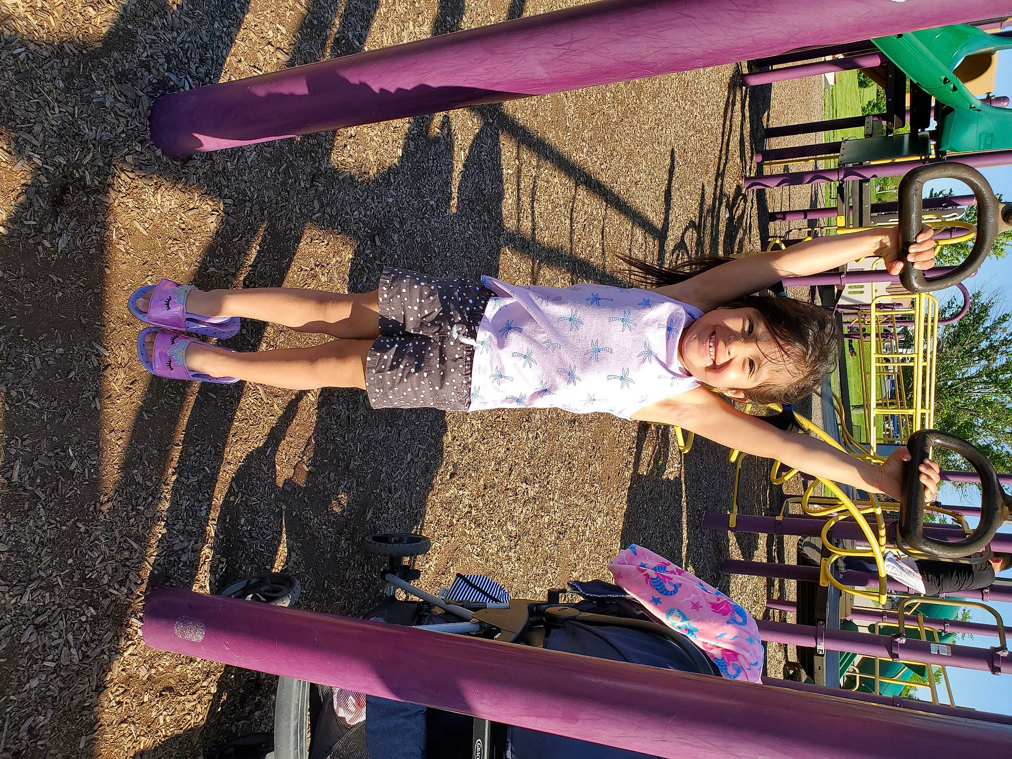 Diana is registered to the contest to win money with this photo: child, city, electric_blue, fun, human_leg, joy, leisure, machine, magenta, outdoor_play_equipment, pattern, person, pink, play, purple, recreation, sock, t_shirt, thigh, toddler