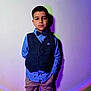Aaron joined the competition — help win amazing prizes! child, boy, portrait, vest, bow_tie, shirt, pants, standing, shadow, colorful_light, wall, indoor, serious_expression, fashion, casual, clothing, person, young, lighting, background
