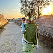 Leya Jennah participe au concours pour gagner de l'argent avec cette photo : adult, ball, blanket, clothing, coat, family, female, hugging, people, person, sport, tennis, tennisball, woman