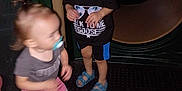 Ezekiel is registered to the contest to win money with this photo: child, children, playground, play, smile, blur, pacifier, toddler, shorts, shirt, sandals, dark, night, playstructure, fun, movement, happy, person, outdoor, toy