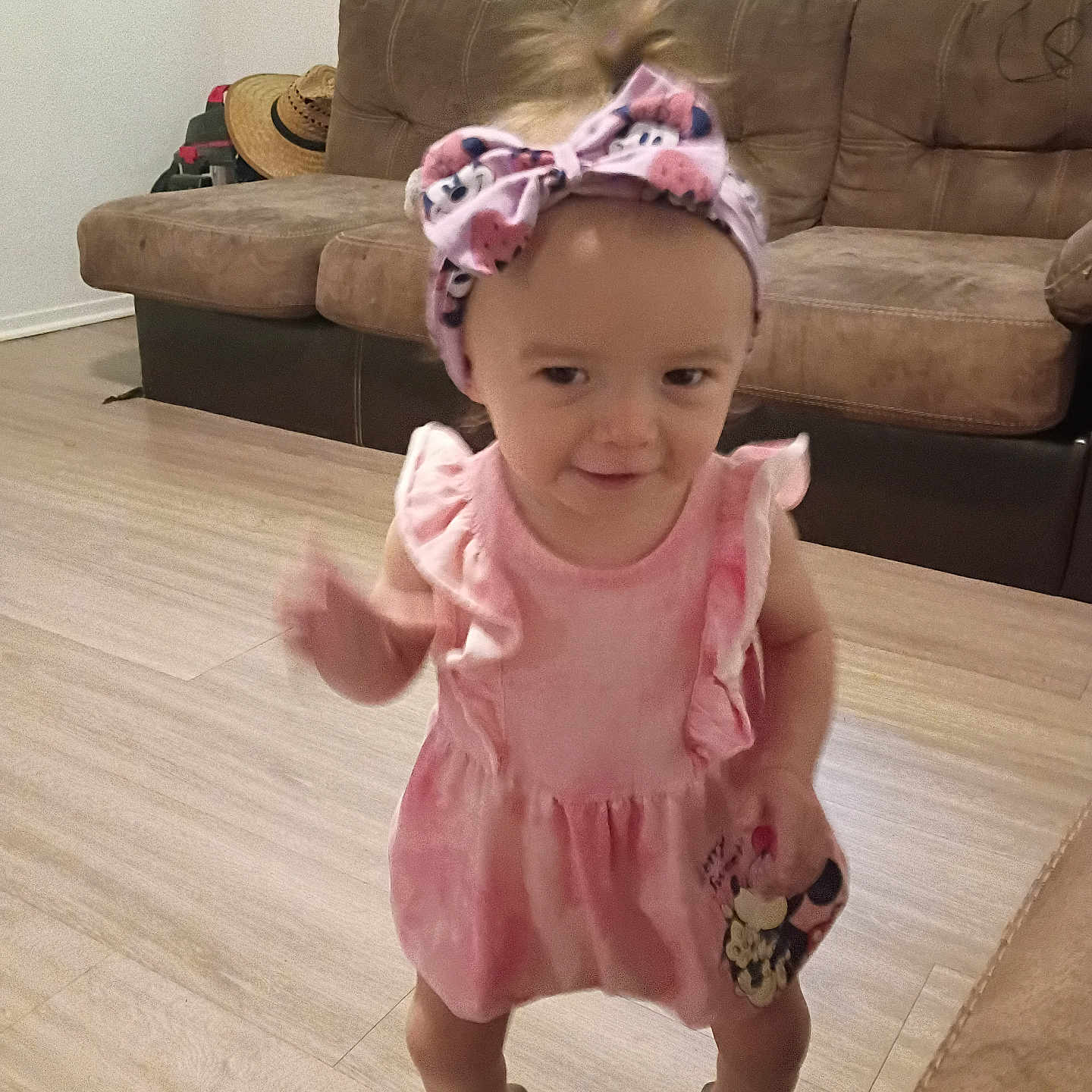 Ensley joined the competition — help win amazing prizes! baby, child, couch, cute, floor, furniture, girl, hat, headband, home, indoor, person, pink_dress, playful, shoes, smile, standing, toddler, wooden_floor, young_child