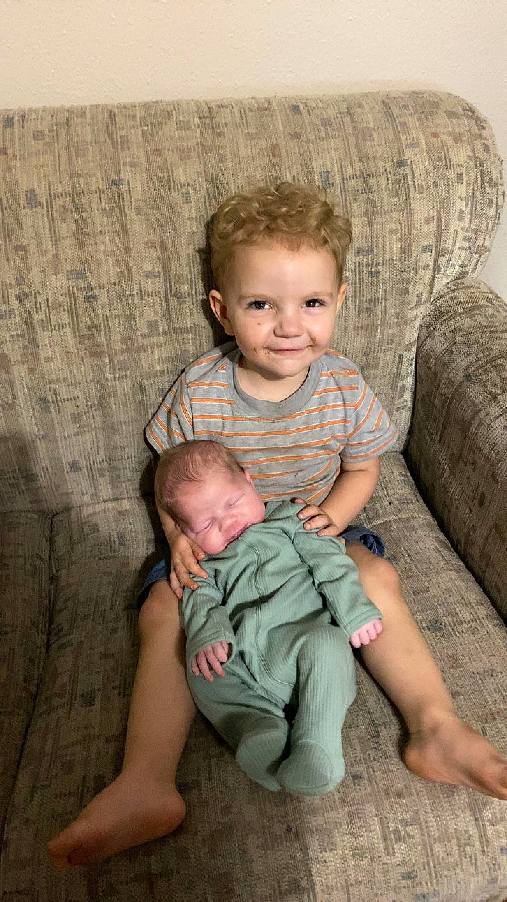 Lilith joined the competition — help win amazing prizes! baby, baby_toddler_clothing, cheek, child, comfort, couch, eye, face, facial_expression, fun, happy, head, joy, lap, leg, mammal, person, skin, smile, t_shirt