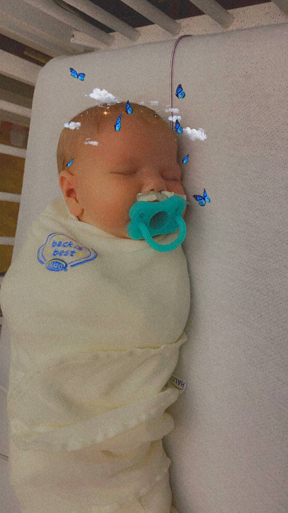 Lilith is registered to the contest to win money with this photo: abdomen, baby, baby_products, baby_safety, baby_toddler_clothing, baby_toys, chest, child, elbow, fashion_accessory, hat, headgear, linens, person, sleeve, t_shirt, textile, toddler