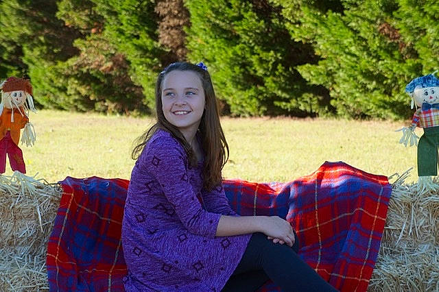 Alyssa joined the competition — help win amazing prizes! adaptation, brown_hair, design, fun, grass, joy, leisure, long_hair, pattern, person, photography, picnic, plaid, plant, recreation, sitting, smile, style, tartan, textile