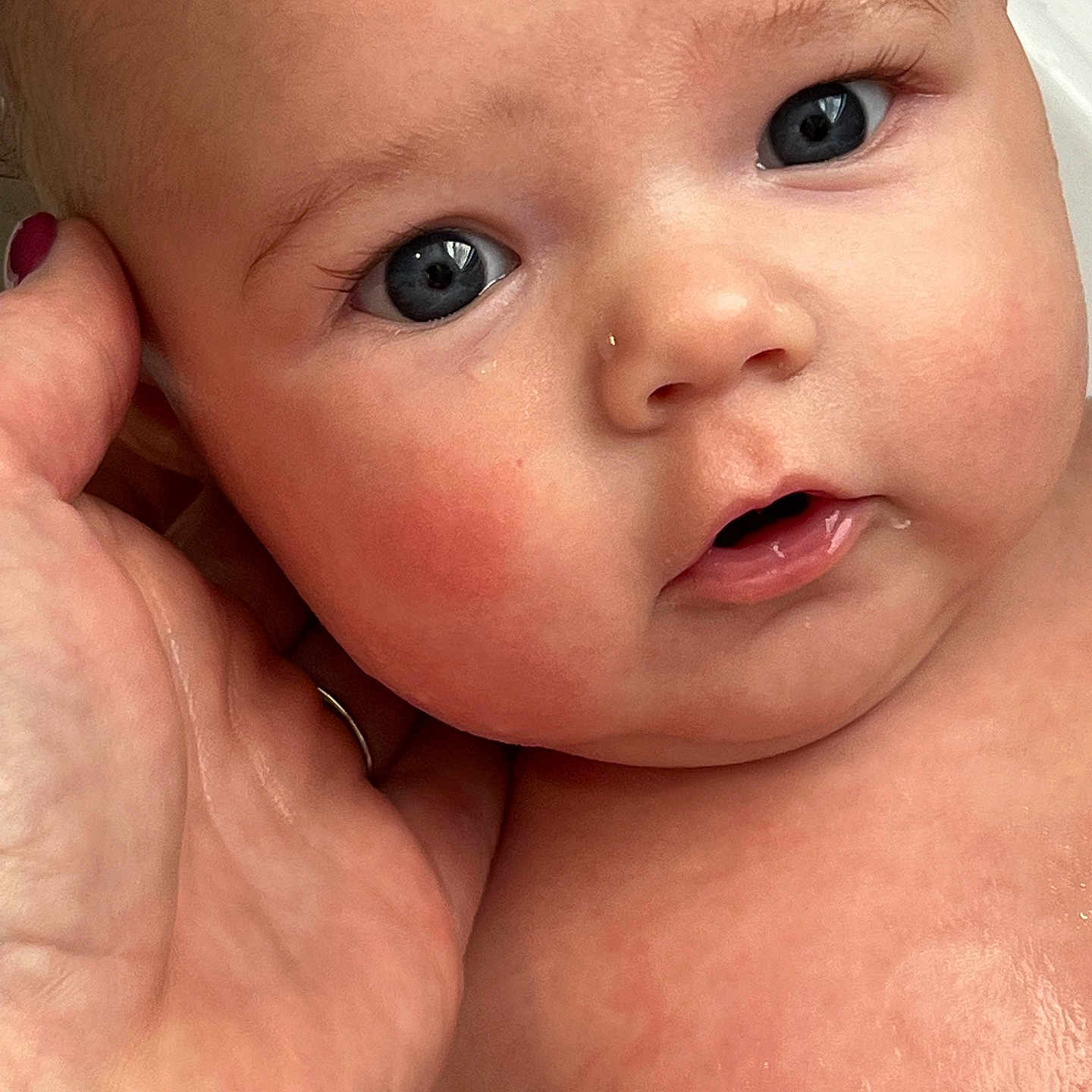 Clara joined the competition — help win amazing prizes! baby, close_up, face, blue_eyes, hand, skin, cheeks, infant, portrait, expression, cuteness, child, human, person, newborn, soft_skin, gaze, fingernails, tenderness, love