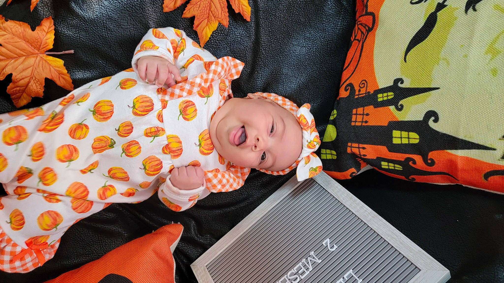 Lesly is registered to the contest to win money with this photo: audio_equipment, baby, baby_products, baby_toddler_clothing, baby_toys, child, comfort, design, fun, head, headwear, linens, orange, pattern, person, pink, room, sitting, sleeve, stuffed_toy