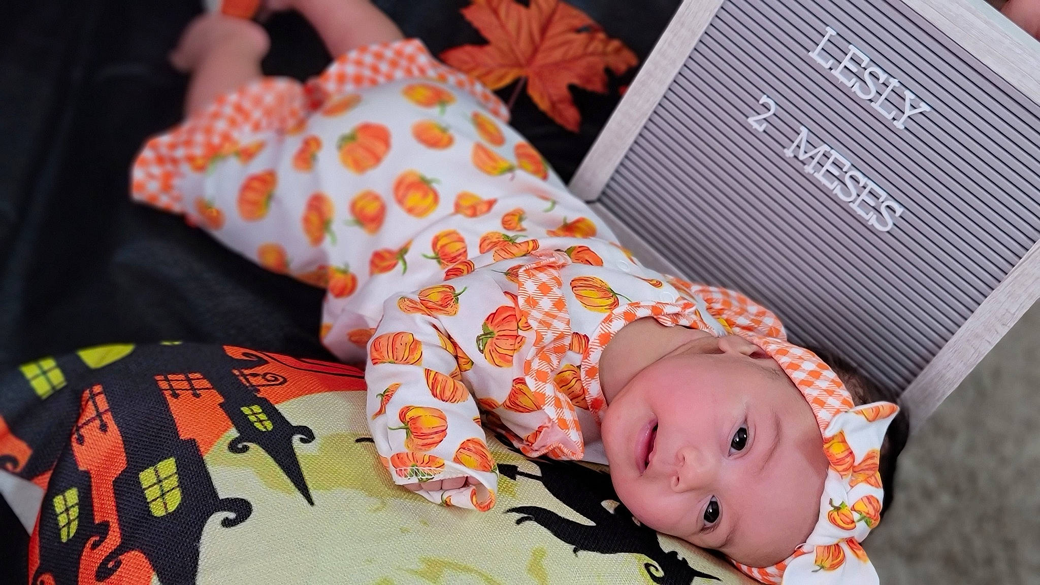 Lesly is registered to the contest to win money with this photo: baby, baby_products, baby_safety, baby_toddler_clothing, baby_toys, bedding, child, doll, font, headwear, linens, orange, pattern, person, pink, room, skin, sleeve, stuffed_toy, textile