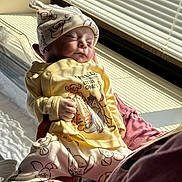 Silas is registered to the contest to win money with this photo: baby, newborn, sleeping, person, clothing, hat, window, sunlight, bed, blanket, hand, pajamas, indoor, infant, soft_light, cute, resting, striped_shadows, toddler, caring