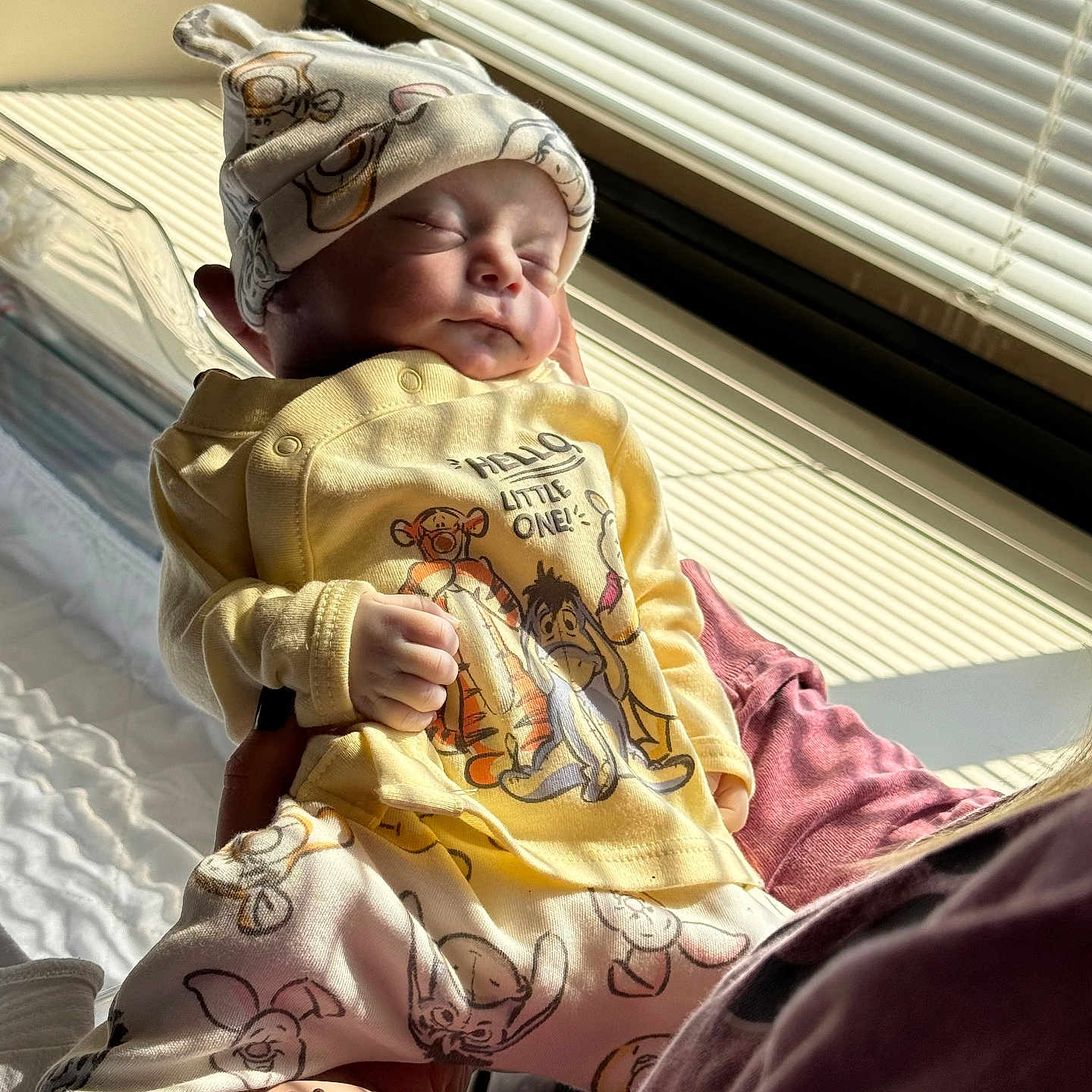Silas is registered to the contest to win money with this photo: baby, newborn, sleeping, person, clothing, hat, window, sunlight, bed, blanket, hand, pajamas, indoor, infant, soft_light, cute, resting, striped_shadows, toddler, caring