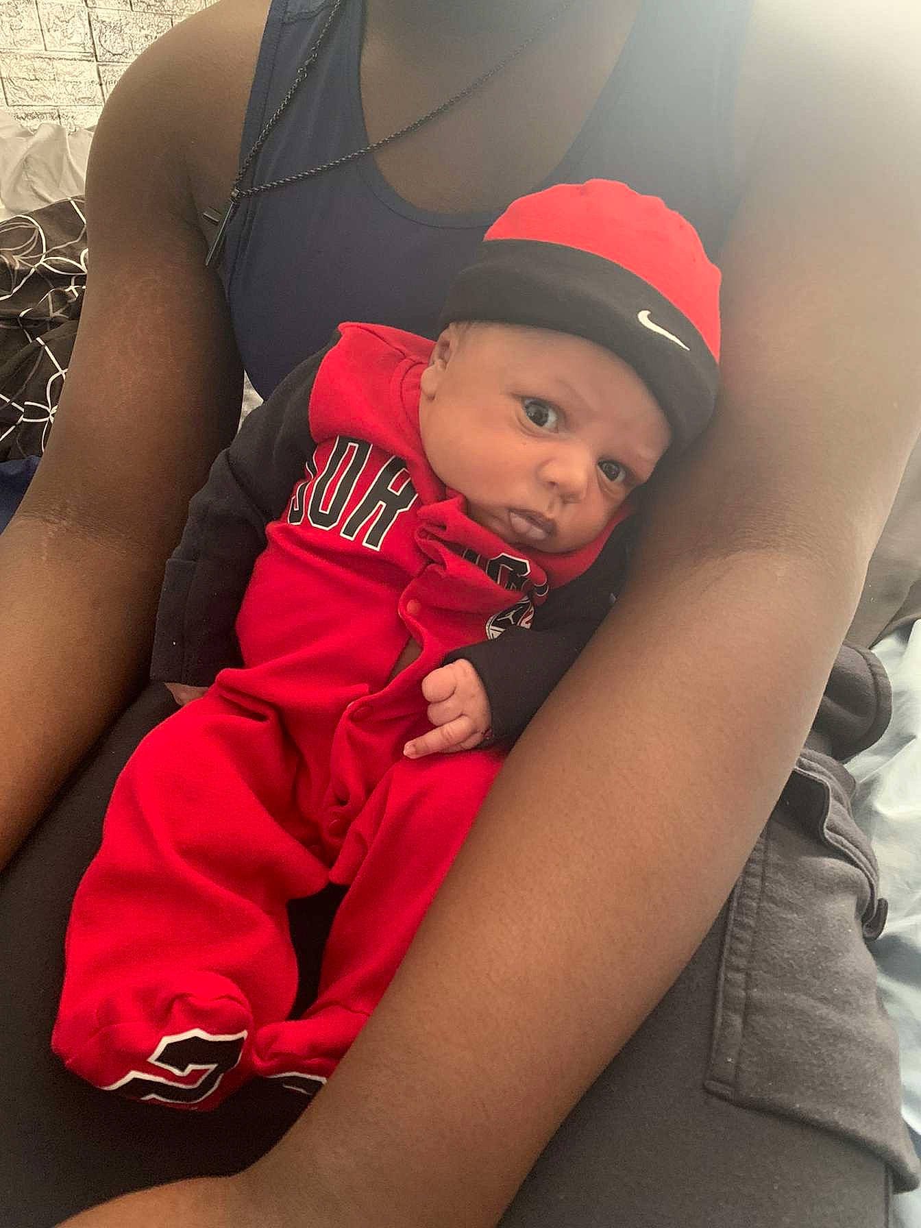 Brandon Leon Thompson is registered to the contest to win money with this photo: arm, baby, baseball_cap, cap, child, comfort, elbow, finger, flash_photography, happy, headwear, human_leg, joint, muscle, person, shoulder, sitting, sleeve, t_shirt, thigh