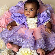 Aaliyah is registered to the contest to win money with this photo: baby, child, dress, purple, pink, flowers, flower_arrangement, portrait, cute, infant, sitting, decorative, costume, puffy_sleeves, soft_lighting, studio_photo, young_child, pretty, adorable, floral_background