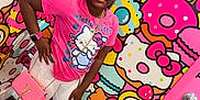 Kenyla is registered to the contest to win money with this photo: accessories, bracelet, braided_hair, child, colorful_background, donuts, fashion, girl, happy, hello_kitty, indoor, macarons, pink_clothing, portrait, purse, sandals, smiling, standing, wall_art, white_shorts