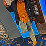 Kenyla is registered to the contest to win money with this photo: blue, boots, brown, bun_hairstyle, carpet, casual_clothing, change_machine, fanny_pack, glasses, indoor, jacket, jeans, patterned_floor, peace_sign, person, poster, roller_skating_rink, standing, tshirt, wall