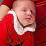 baby, sleeping, infant, red_clothing, santa_outfit, white_fur_trim, closeup, portrait, person, child, holiday, christmas, cozy, warm, hands, resting, cute, soft_texture, indoor, festive