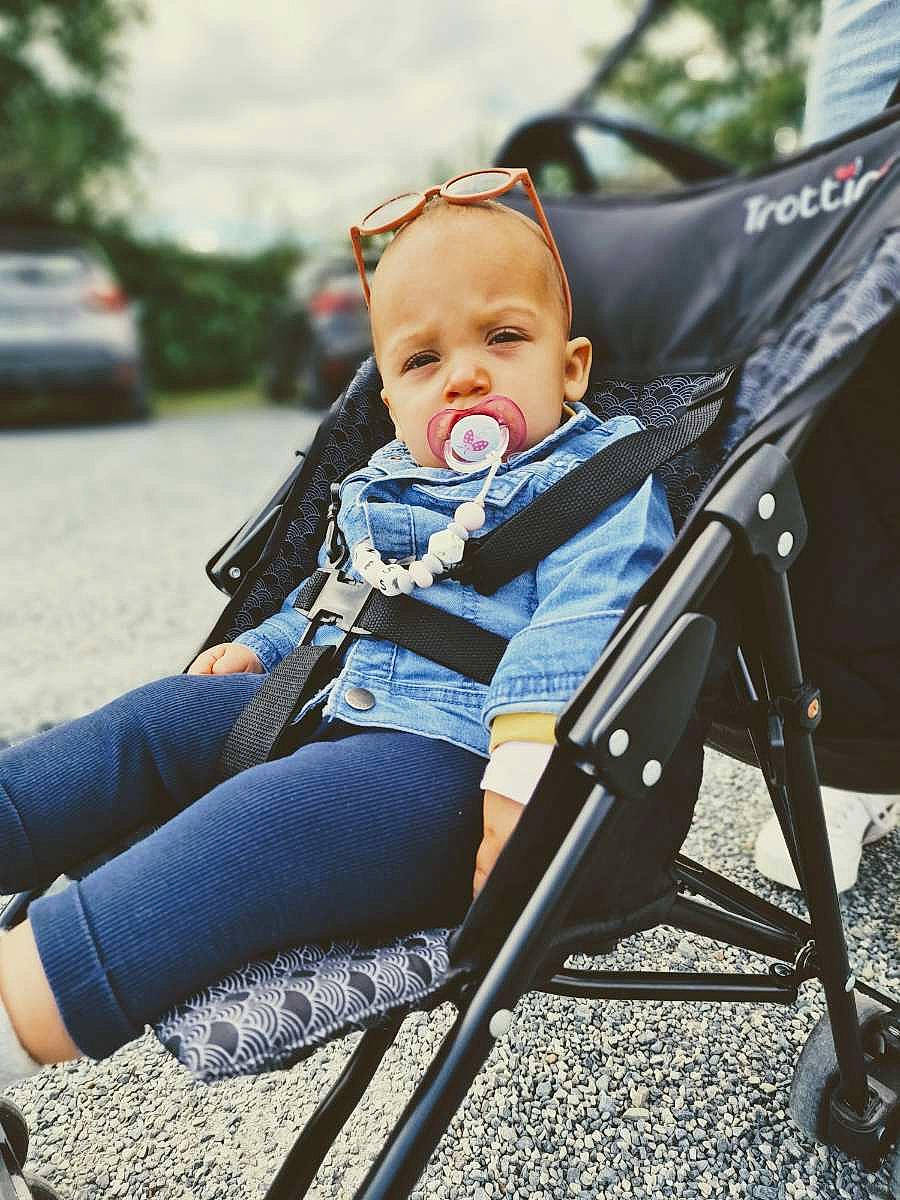 Inès a rejoint le concours — aidez-le/la à gagner de superbes lots ! baby, baby_carriage, baby_products, baby_toddler_clothing, chair, child, comfort, electric_blue, fun, grass, happy, head, human_leg, leisure, people_in_nature, person, plant, sitting, thigh, toddler