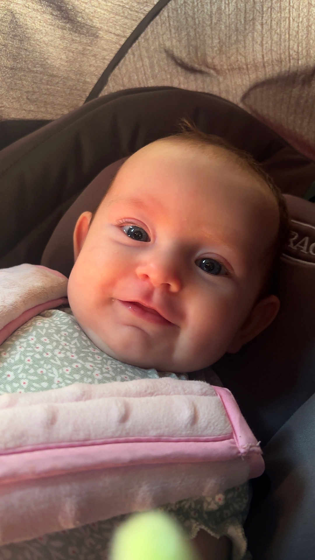 Serenity is registered to the contest to win money with this photo: baby, infant, face, smile, eyes, blanket, clothing, car_seat, child, cute, portrait, indoors, soft_light, closeup, warm_colors, skin, head, baby_girl, expression, happy