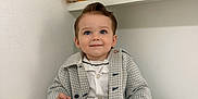 Elijah-James is registered to the contest to win money with this photo: toddler, child, baby, smiling, coat, shorts, socks, indoor, white_wall, sitting, teddy_bear, baby_shoes, photo_frame, shelf, portrait, cute, happy, clothing, person, home