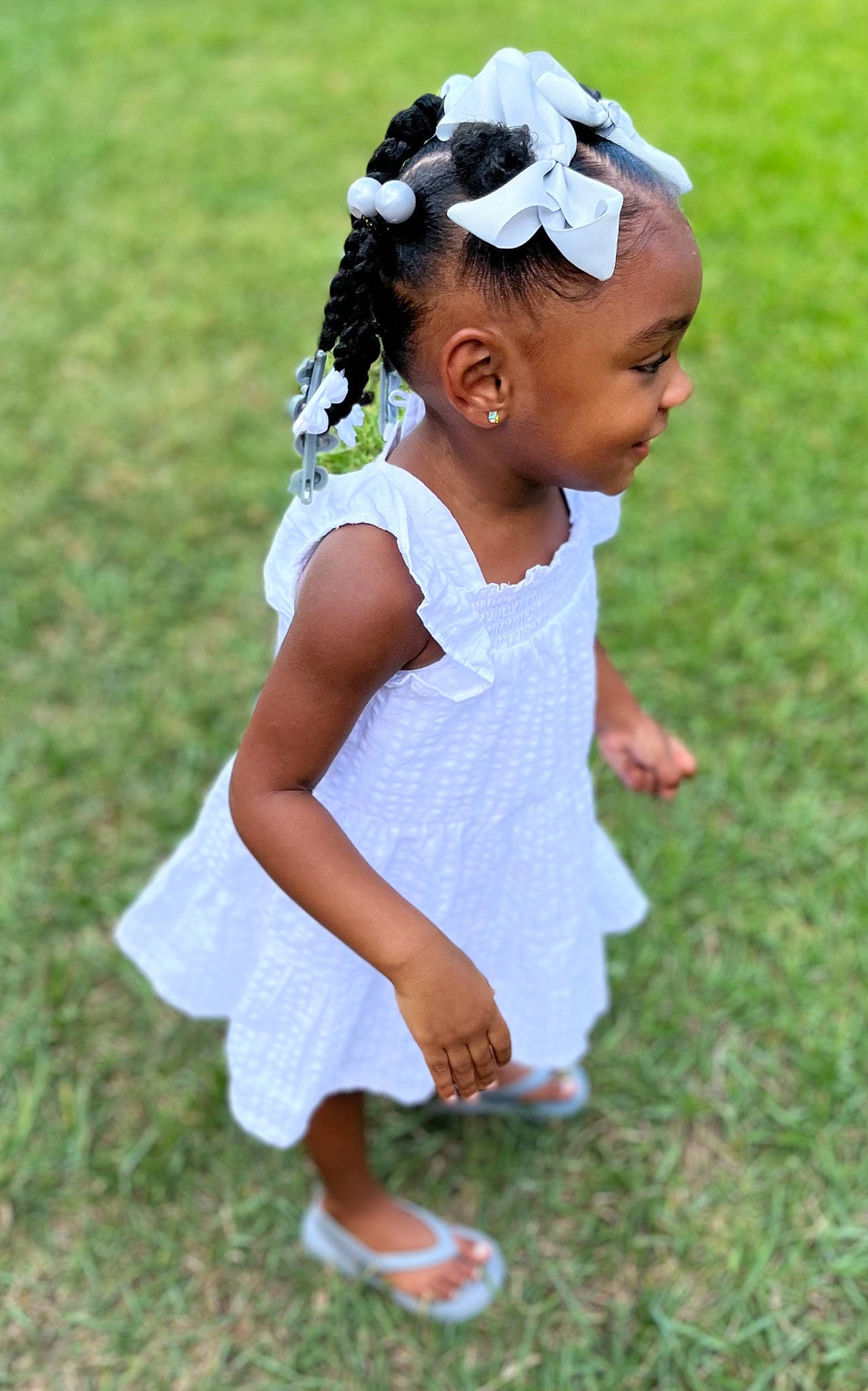 Reminisce is registered to the contest to win money with this photo: baby, baby_toddler_clothing, day_dress, dress, gesture, grass, grass_family, grassland, hair, happy, head, headband, headgear, meadow, natural_environment, people_in_nature, person, sleeve, smile, toddler