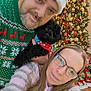 Axle joined the competition — help win amazing prizes! man, woman, dog, christmas_tree, christmas_lights, christmas_sweater, santa_hat, glasses, holiday, gift_wrap, presents, festive, smiling, indoor, portrait, celebration, happy, together, cozy, family