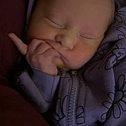 Lilly Lynn is registered to the contest to win money with this photo: newborn, baby, sleeping, hoodie, purple_clothing, floral_pattern, hand, face, cozy, infant, child, soft_light, portrait, closeup, peaceful, cute, zipped_clothing, person, indoors, resting