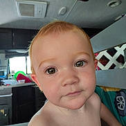 Arielle is registered to the contest to win money with this photo: toddler, child, face, eyes, hair, indoor, kitchen, curious, close_up, portrait, skin, expressionless, young_child, baby, head, person, home, window, furniture, light