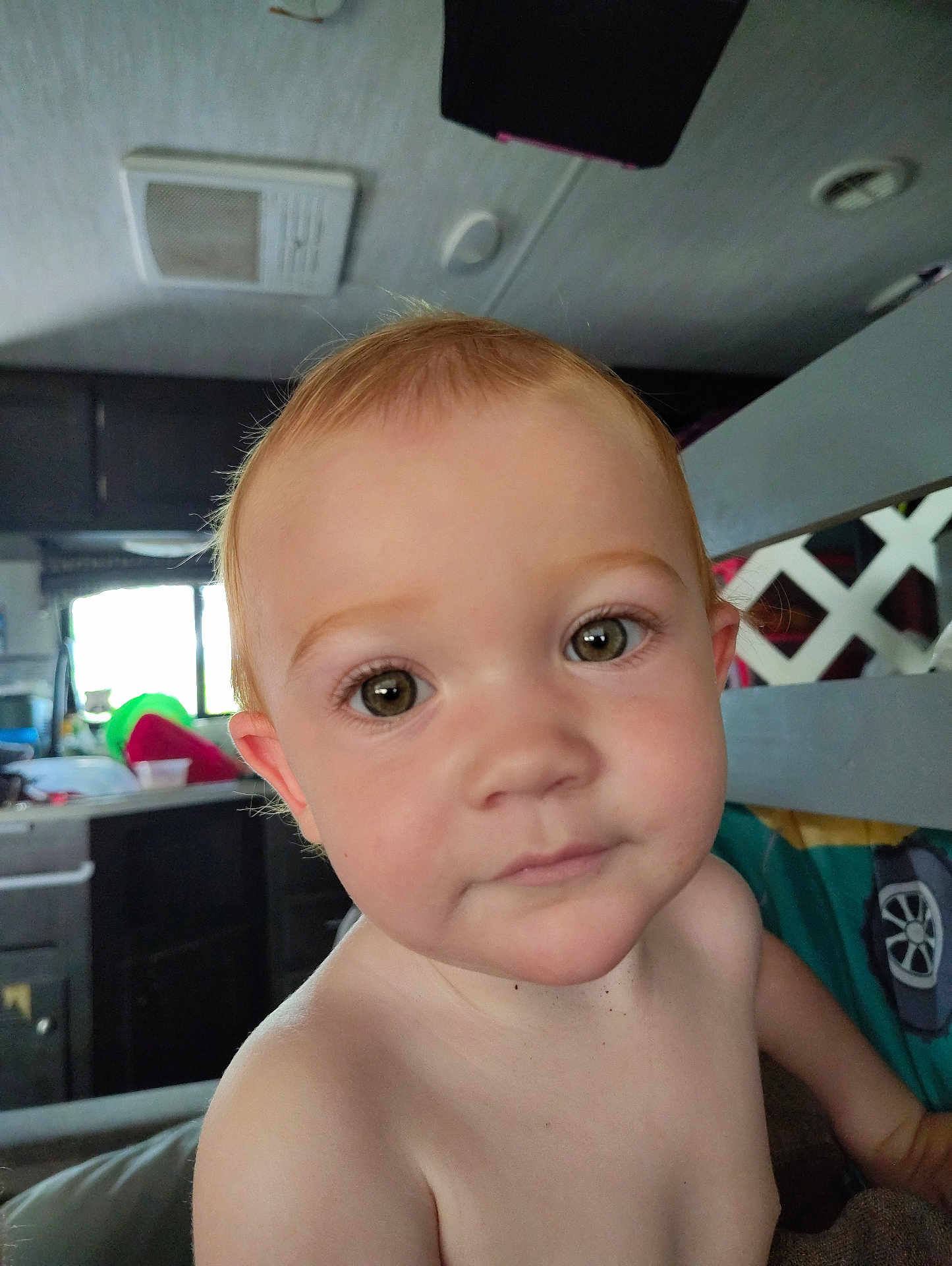 Arielle is registered to the contest to win money with this photo: toddler, child, face, eyes, hair, indoor, kitchen, curious, close_up, portrait, skin, expressionless, young_child, baby, head, person, home, window, furniture, light