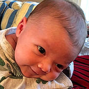 Eleanor joined the competition — help win amazing prizes! baby, infant, face, head, eyes, expression, clothing, cactus_pattern, soft_surface, cushion, indoor, portrait, close_up, child, cute, newborn, resting, curious, cozy, fabric