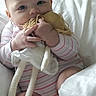 Eleanor is registered to the contest to win money with this photo: baby, infant, bed, pajamas, doll, toy, face, hands, feet, yarn, hair, fabric, room, comfort, child, cute, soft, indoor, sleepwear, sitting