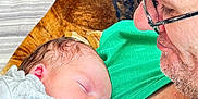 Kayden Jackowicz joined the competition — help win amazing prizes! adult, arm, baby, blanket, closeup, comfort, couch, face, family, glasses, green_shirt, indoor, love, newborn, person, pillow, portrait, resting, skin, sleeping