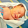 baby, blue, closeup, cute, fabric, face, fresh, head, human, infant, newborn, peaceful, resting, skin, sleeping, smiling, soft, striped, towel, wrapped