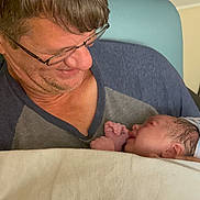 Kayden Jackowicz joined the competition — help win amazing prizes! man, baby, newborn, glasses, blanket, indoor, portrait, smile, holding, family, love, child, person, tender, hospital, care, closeup, face, caring, bond
