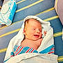 Kayden Jackowicz is registered to the contest to win money with this photo: baby, baby_wipes, blanket, blue, cushion, cute, face, head, hospital, indoor, infant, newborn, peaceful, resting, skin, sleeping, smiling, striped, toy_book, wrapped