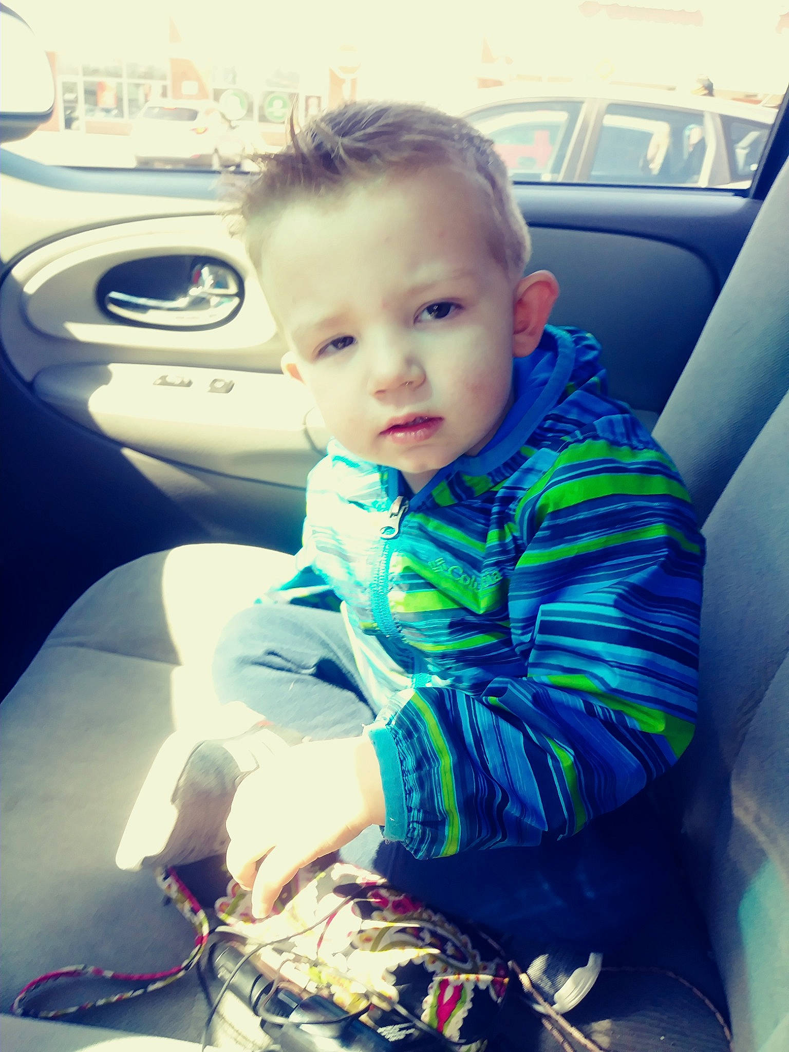 Logan is registered to the contest to win money with this photo: auto_part, baby, baby_in_car_seat, car, car_seat, cheek, child, cool, family_car, fun, luxury_vehicle, person, product, sitting, skin, smile, toddler, vacation, vehicle, vehicle_door