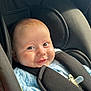 baby, child, car_seat, blue_blanket, smiling, happy, infant, face, eyes, clothing, seatbelt, safety, indoors, person, cute, young, portrait, soft_light, knitwear, comfort
