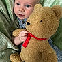 baby, blanket, child, comfort, cuddly, cute, expression, face, green, hand, indoors, infant, overalls, plush_toy, portrait, soft_texture, striped_clothing, teddy_bear, toy, young